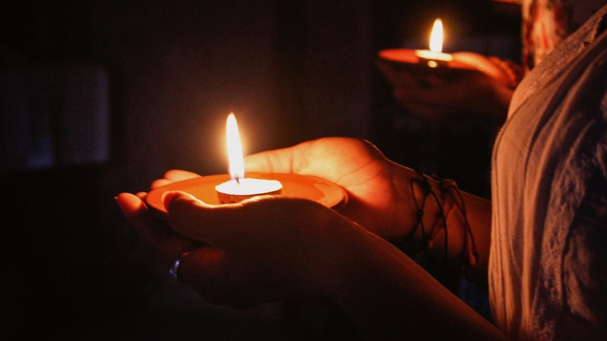 a woman is holding a candle