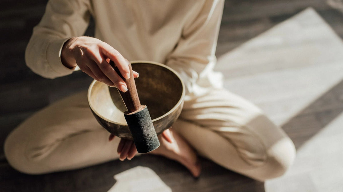 woman is using a singing bowl