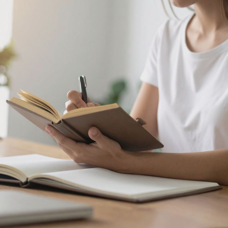 woman is writing a journal