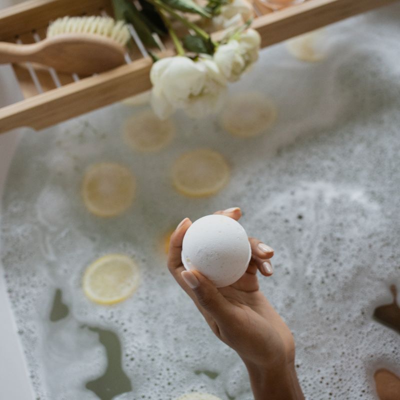 a woman is holding a bath bomb