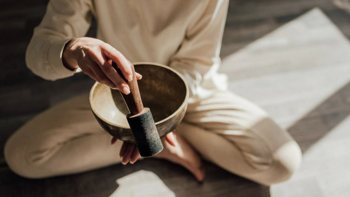 woman is using a singing bowl