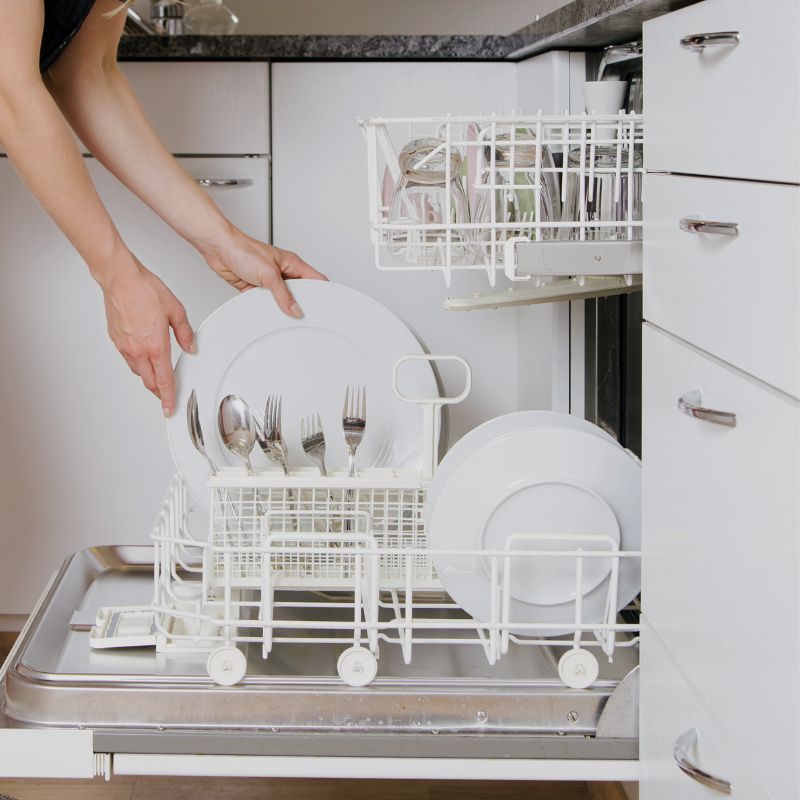 woman is emptying dishwasher