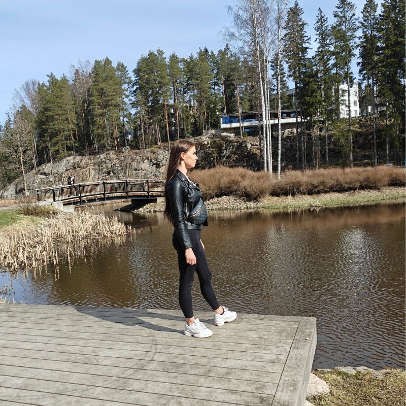 a woman is looking at a lake