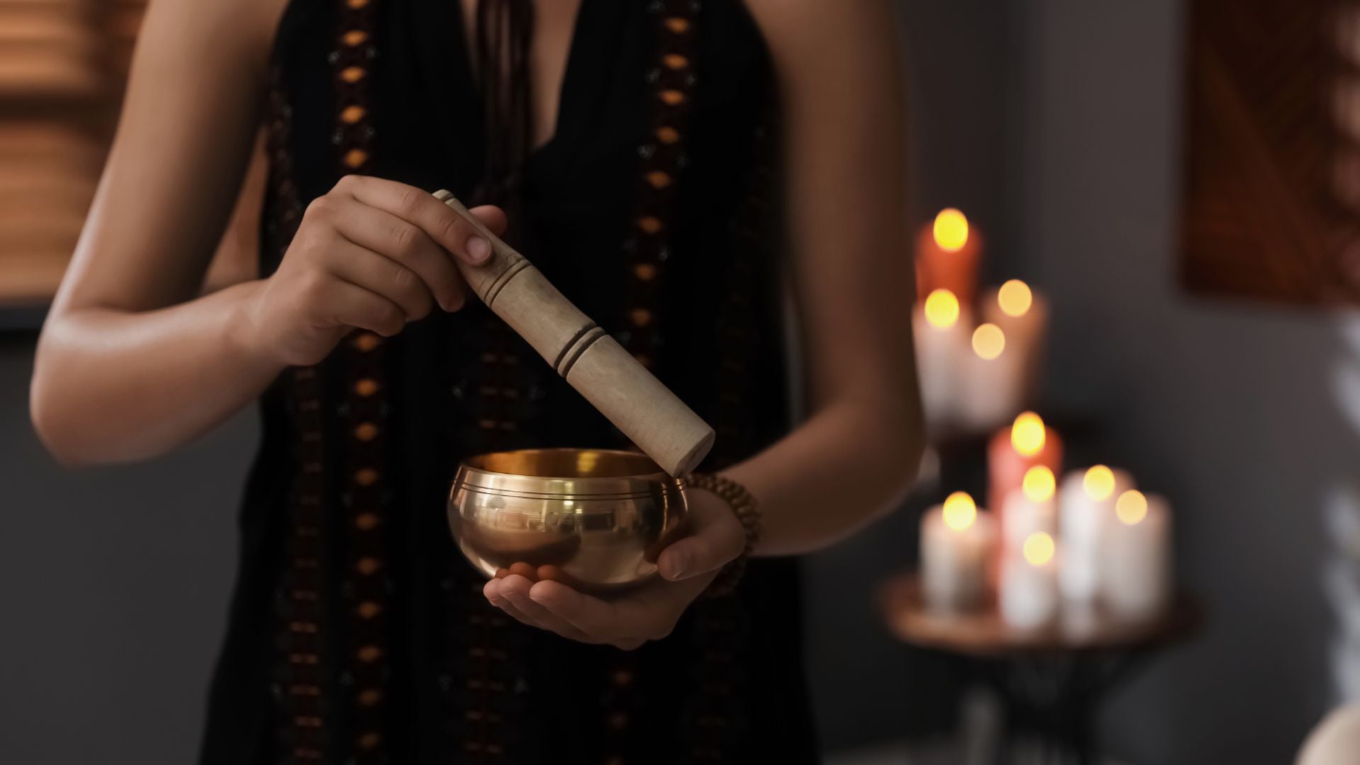 woman is holding a singing bowl