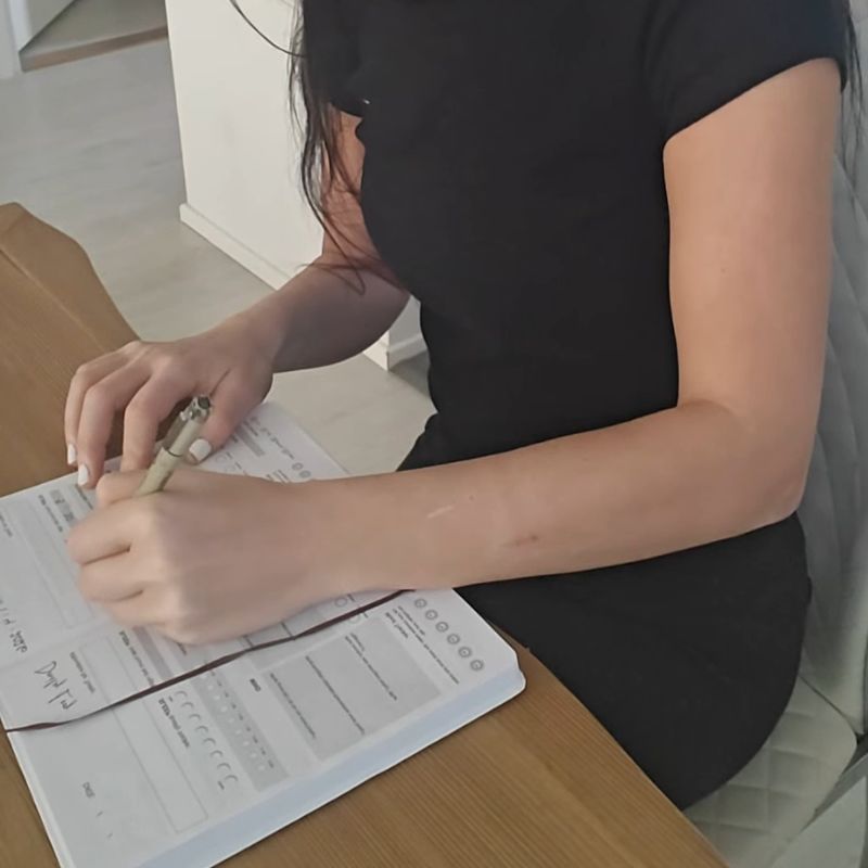 woman is writing a journal