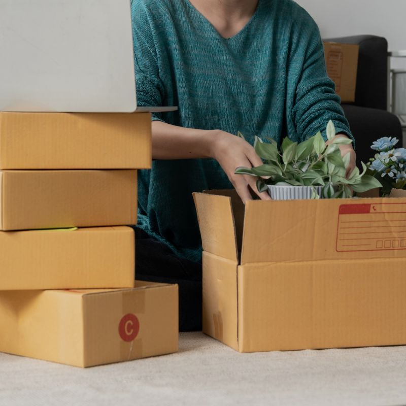 a woman is packing the products